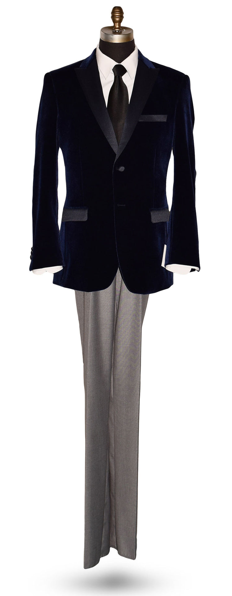 Navy blue velvet tuxedo on a mannequin with a black silk necktie against  white background