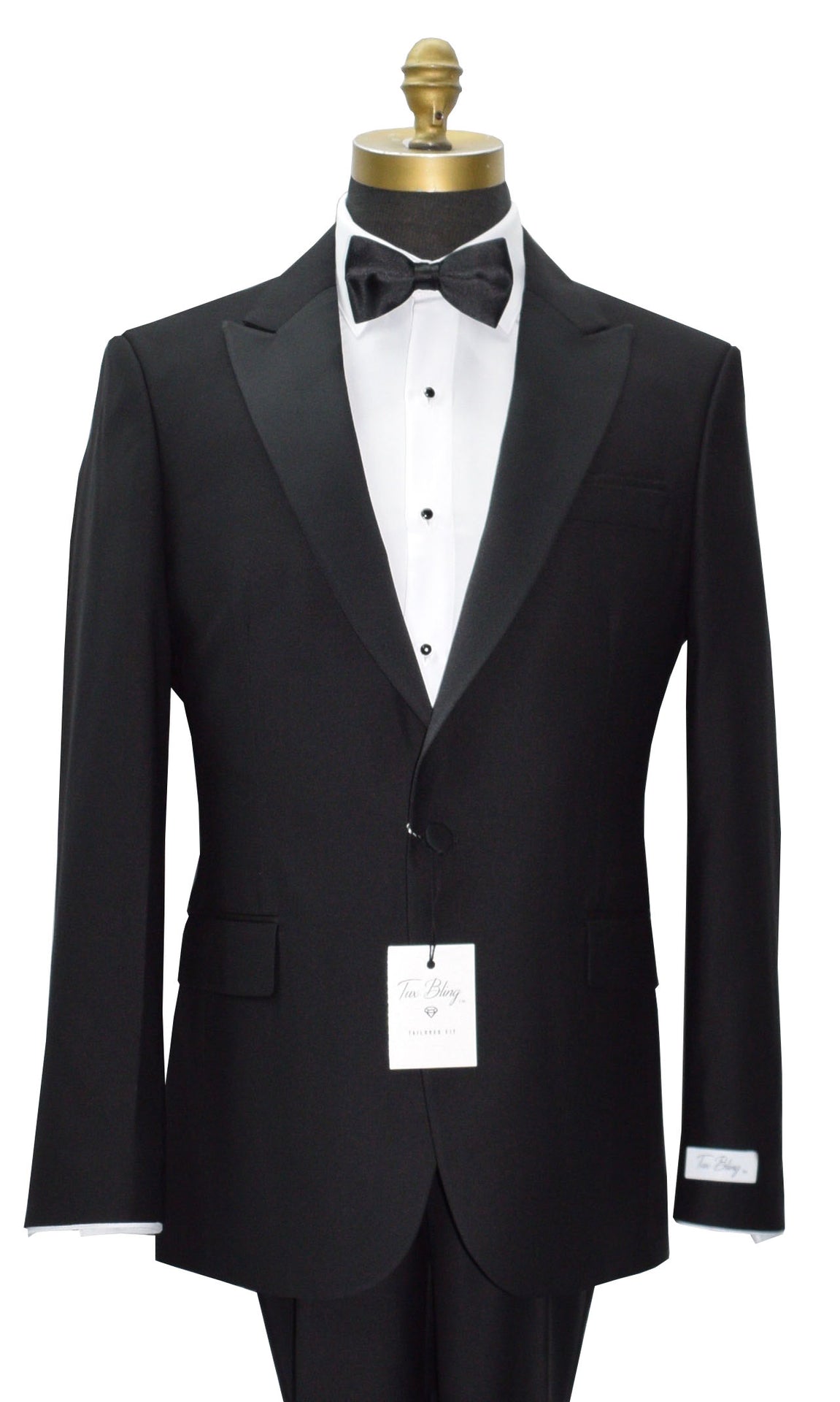 close up black 3 piece peak lapel tuxedo on a mannequin with a white tuxedo shirt and black bowtieand a "tux bling" branded label