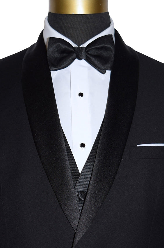 Black shawl-collar tuxedo with a bow tie and a four-button black vest on a mannequin against a white background