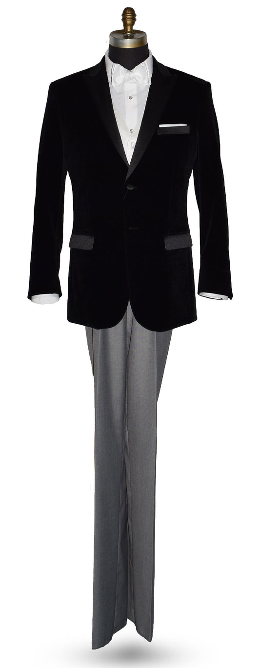 Black velvet tuxedo with white shirt and gray pants and a white satin bowtie on a mannequin against a white background