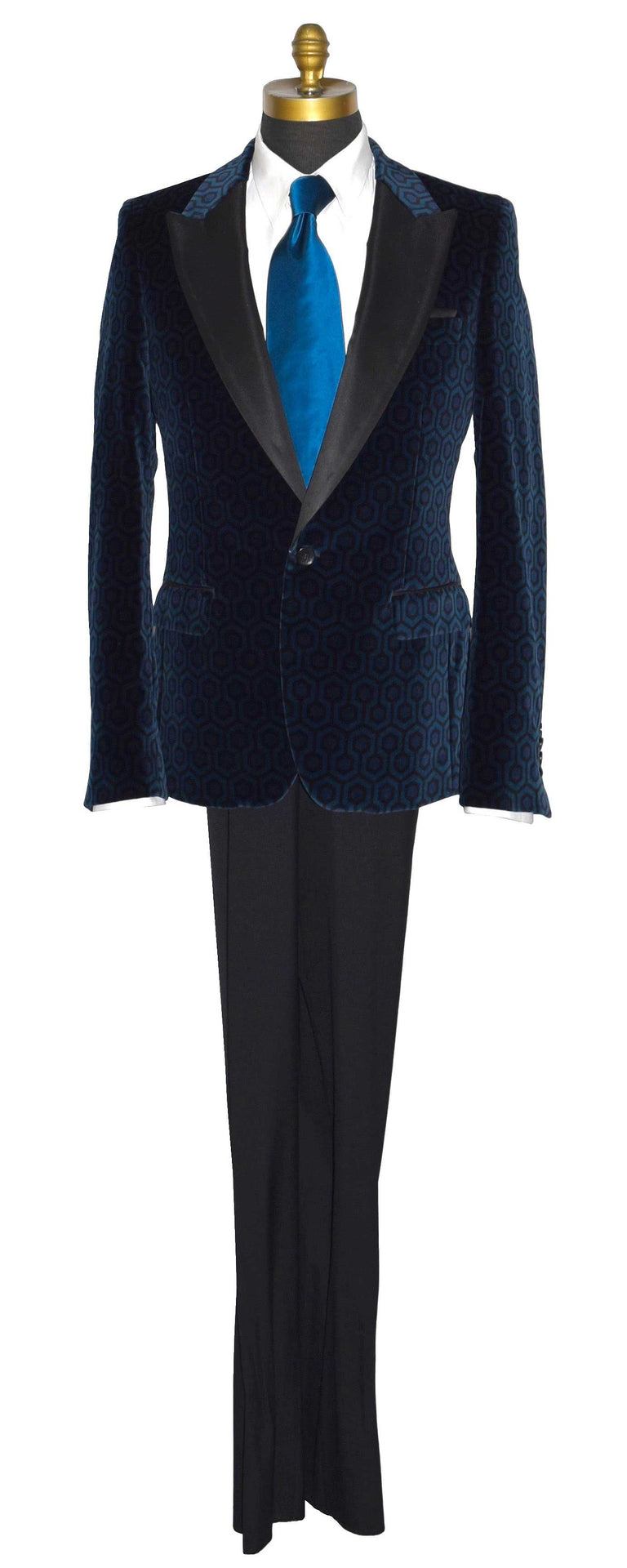 life size mannequin wearing a blue hexagon velvet tuxedo jacket with a white tuxedo shirt and a long blue silk necktie against a white background