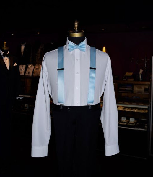 mannequin wearing a capri-blue bowtie and capri-blue suspenders inside a tuxedo shop