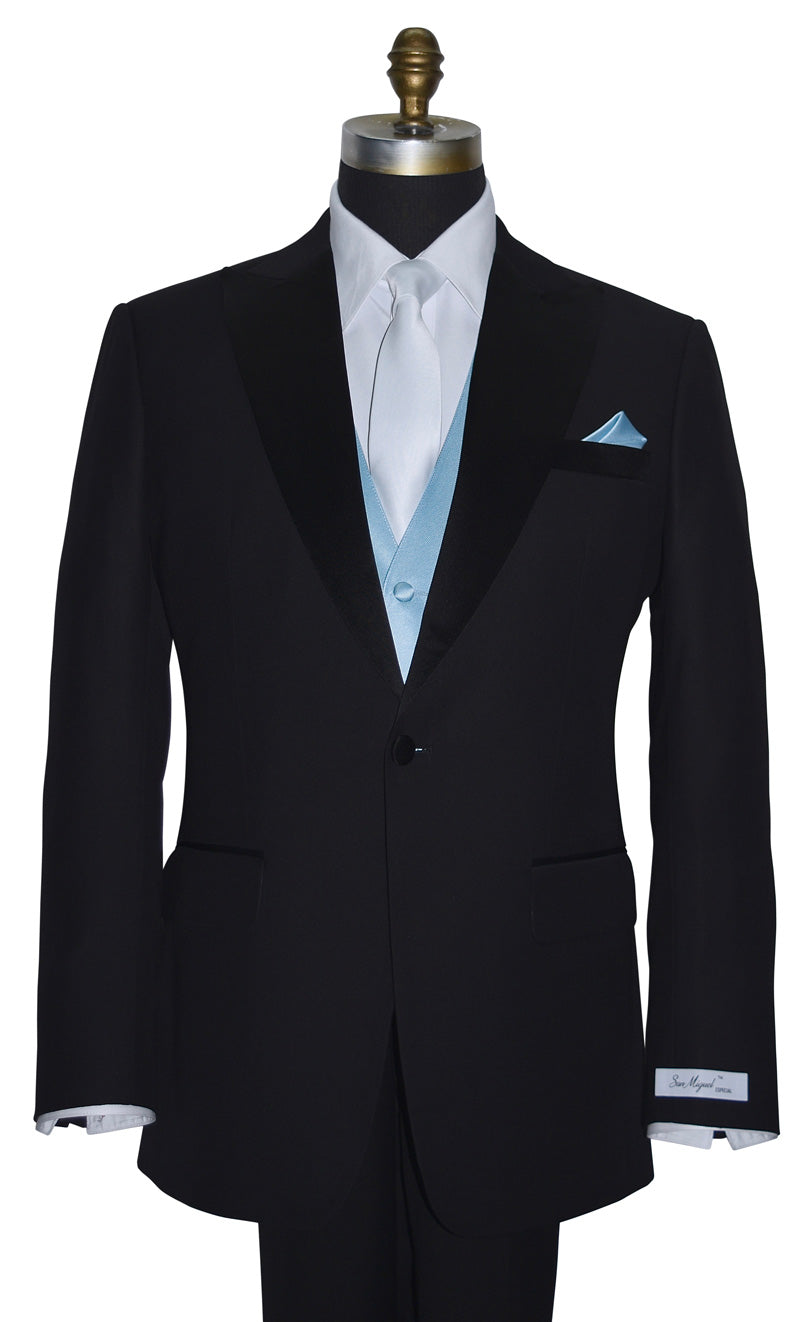 mannequin wearing a "San Miguel Especial" branded black peak-lapel tuxedo and white dress shirt with a capri-blue tuxedo vest and long white satin necktie against a white background