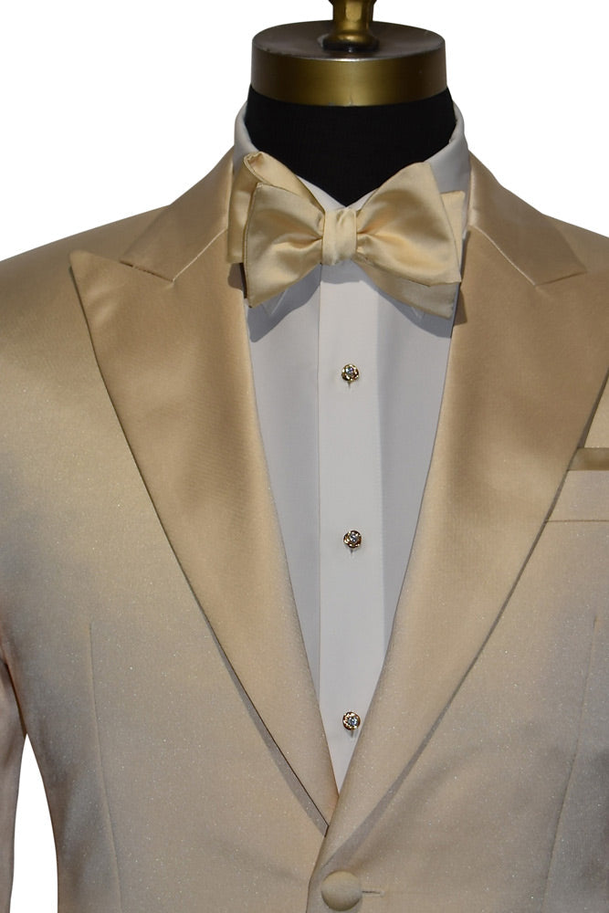 close-up front view mannequin wearing a champagne satin colored dinner jacket with a white tuxedo shirt and a champagne colored "tie-yourself" bowtie with crystal and gold formal jewelry against a white background