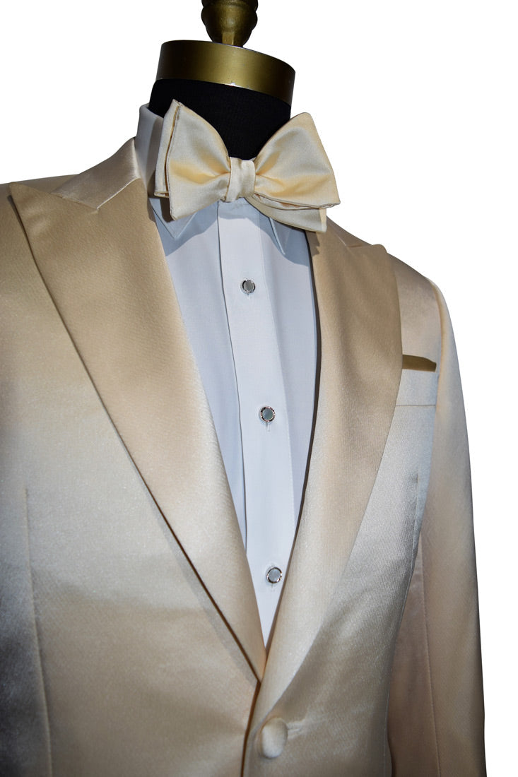 side view close-up front view mannequin wearing a champagne satin colored dinner jacket with a white tuxedo shirt and a champagne colored "tie-yourself" bowtie against a white background