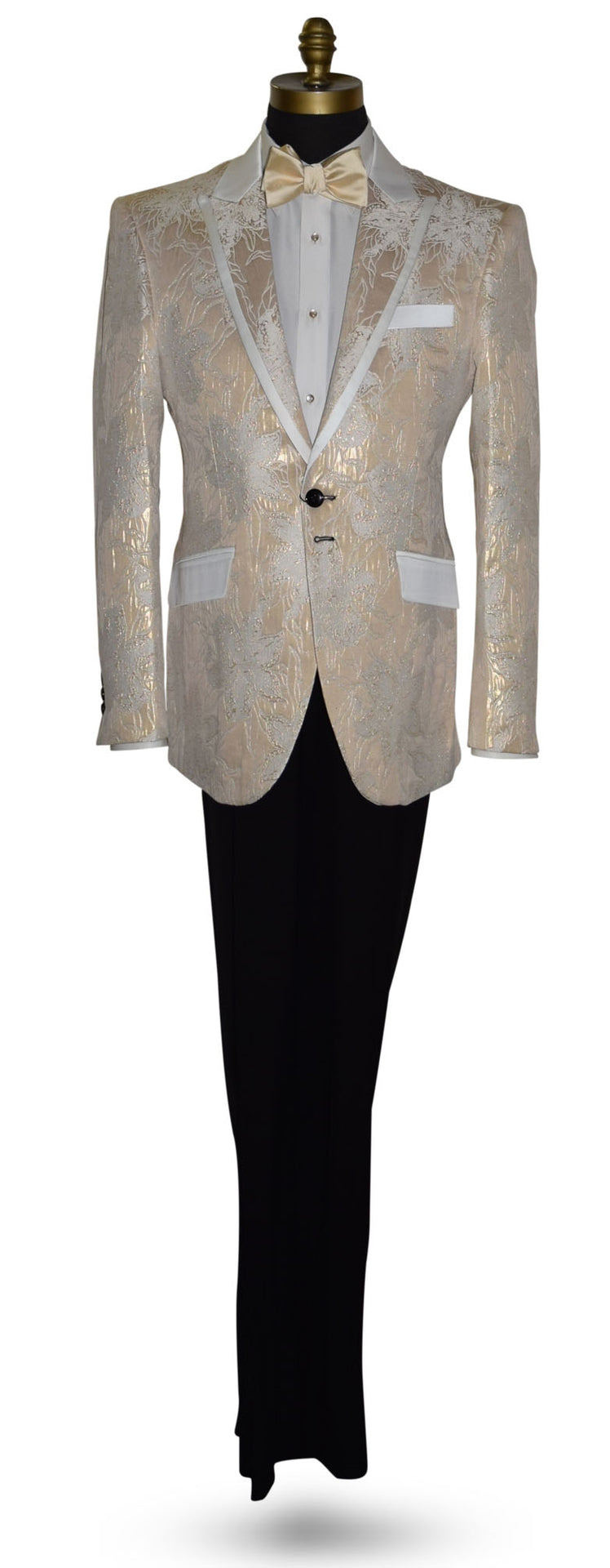 Champagne color tuxedo with satin trim on the peak lapels shown with black pants and a champagne tie-yourself bowtie on a mannequin against a white background
