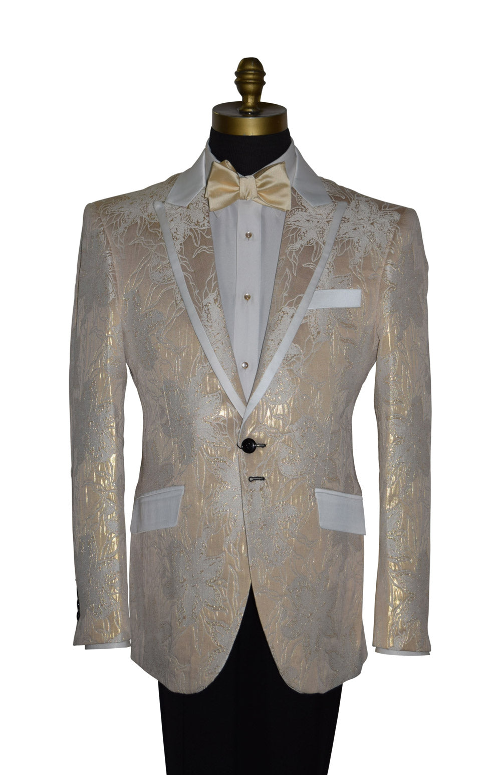 close-up Champagne color tuxedo with satin trim on the peak lapels shown with black pants and a champagne tie-yourself bowtie on a mannequin against a white background