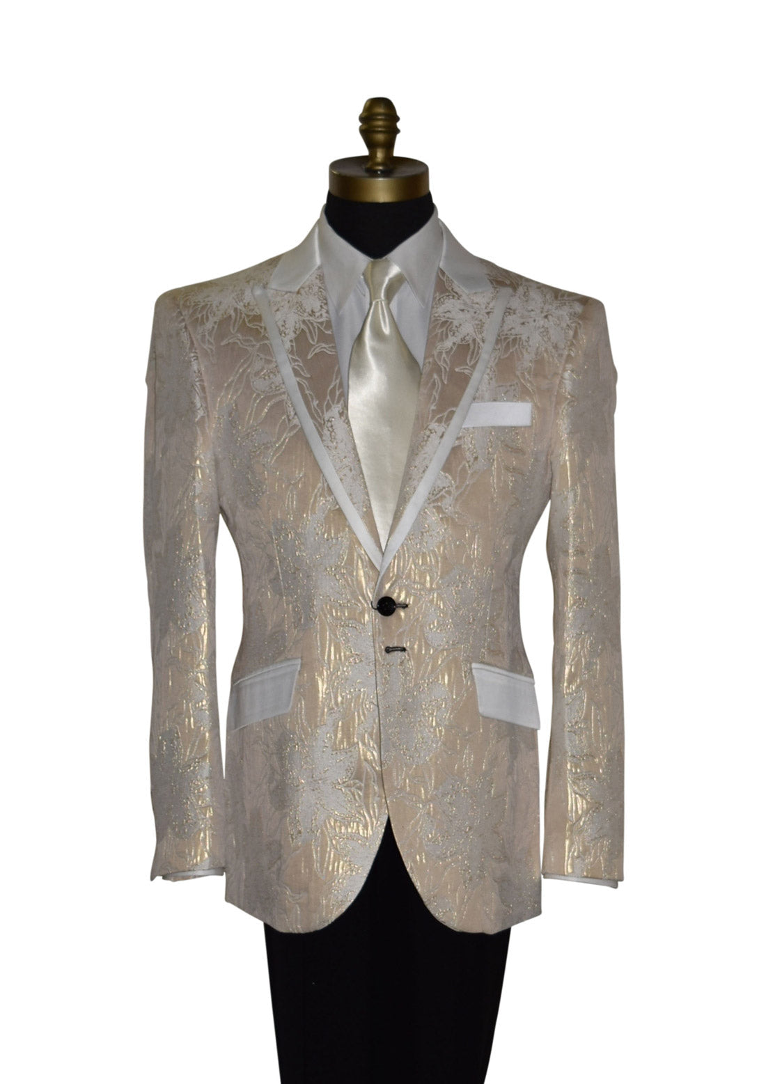 close-up Champagne color tuxedo with satin trim on the peak lapels shown with black pants and a off-white satin necktie on a mannequin against a white background