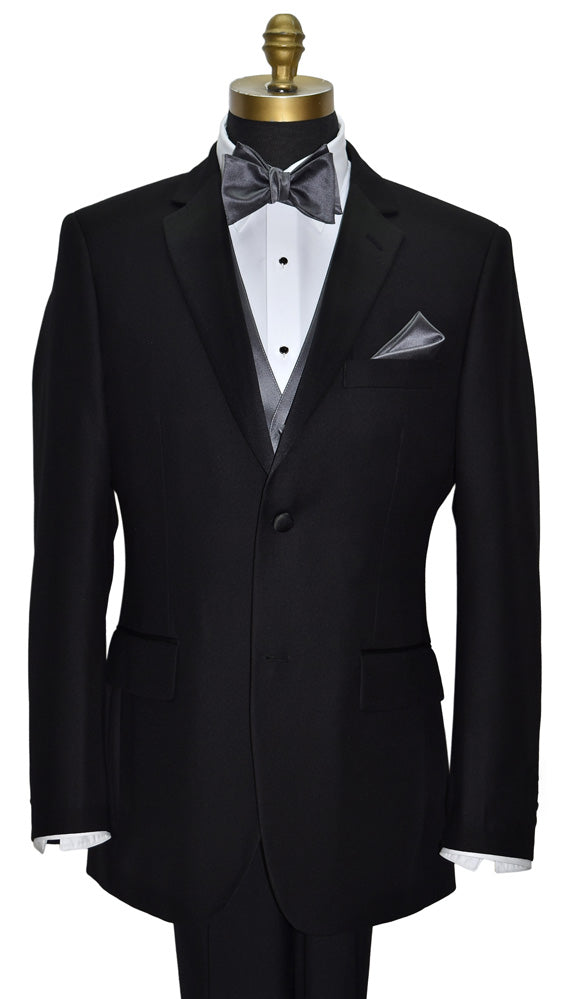 Black notch-lapel tuxedo with white shirt, gray "tie-yourself" bow tie, and pocket square on a mannequin against a white background.