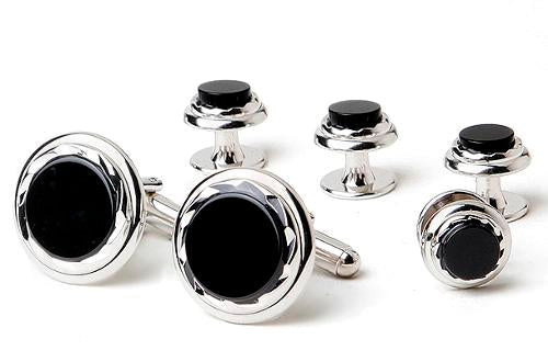close up onyx cufflinks and studs with silver setting against a white background