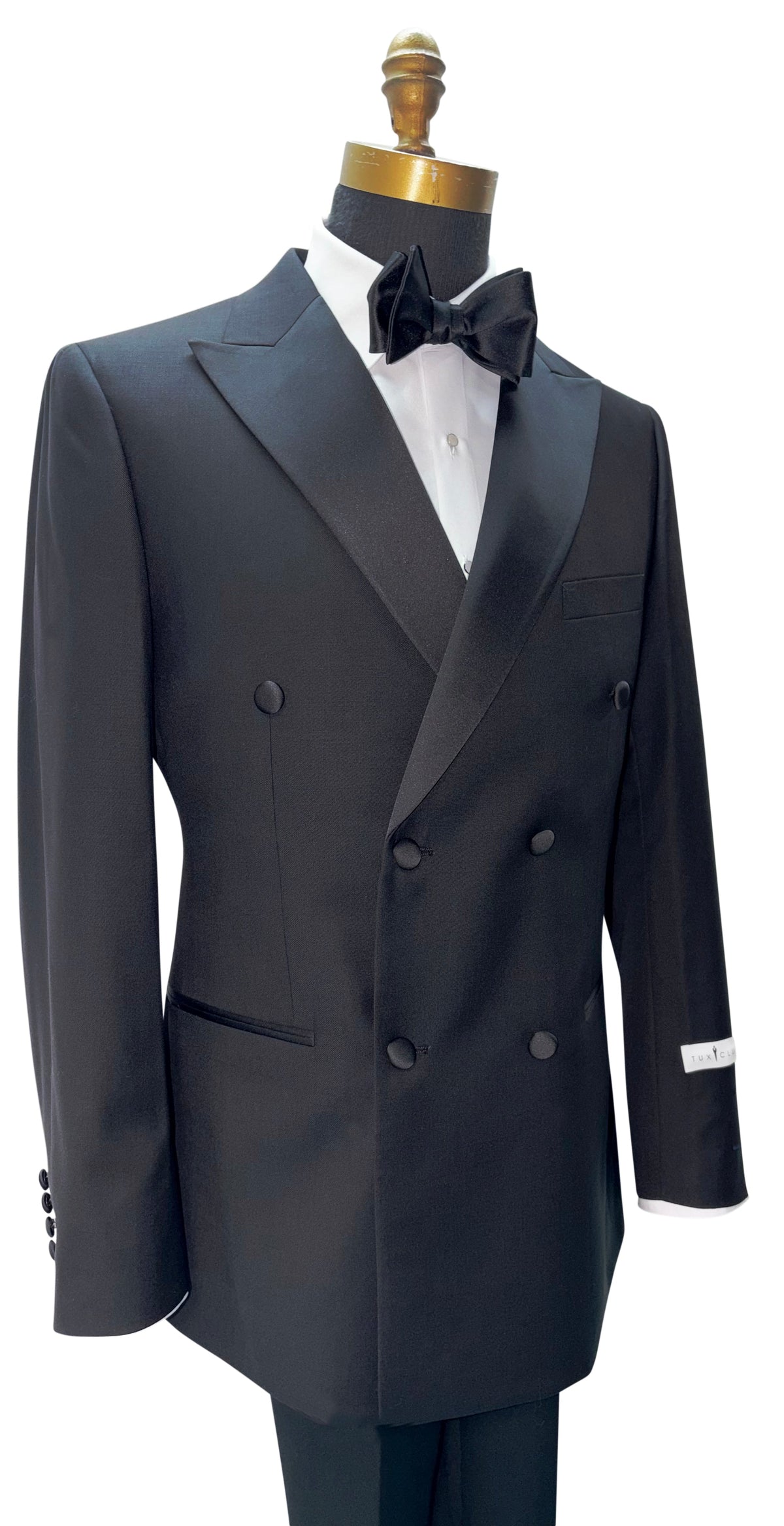 side view -black double breasted tuxedo with a black bowtie against a white background