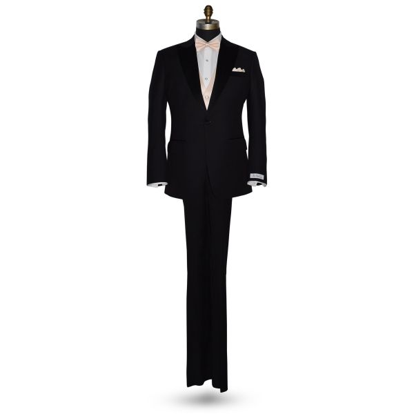 life size full mannequin wearing black tuxedo with nude pre-tied bowtie and nude color vest and pocket handkerchief against a white background