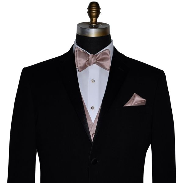 close-up mannequin wearing a black tuxedo with a rose-gold "tie-yourself" bowtie and vest against a white background