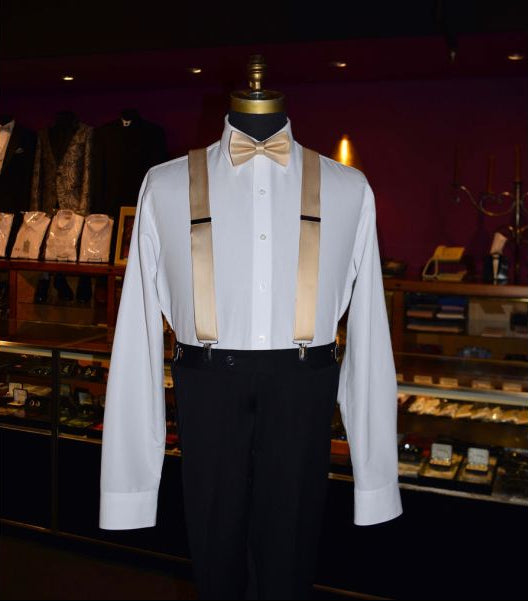 mannequin wearing golden "pre-tied" bowtie with golden satin suspenders inside a tuxedo shop