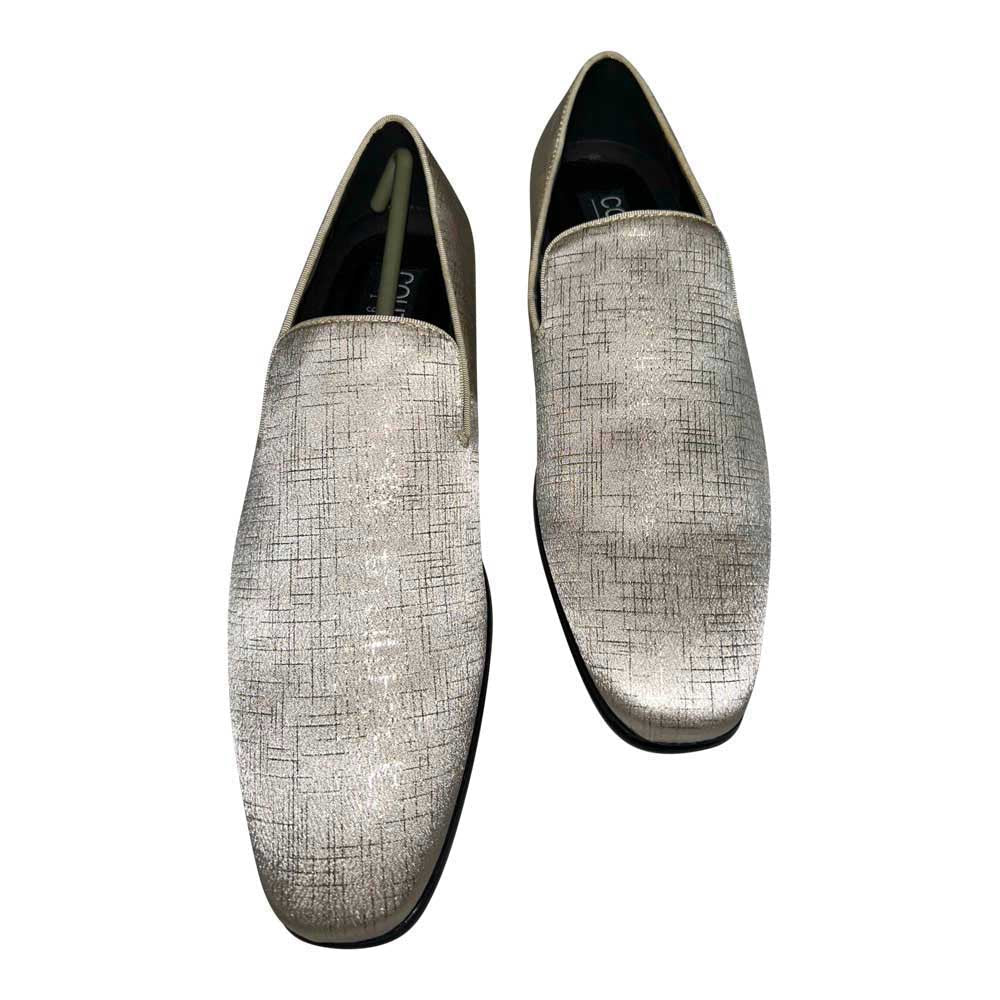 Pair of golden-tan mens loafers on a white background