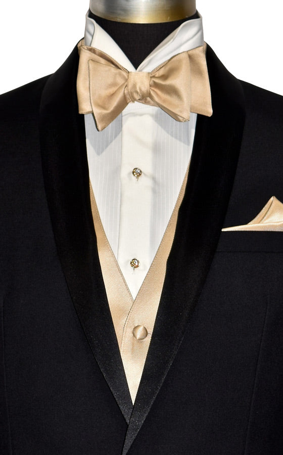 super close-up black shawl collar tuxedo with ivory tuxedo shirt and golden "tie-yourself" bowtie and a golden tuxedo vest against a white background