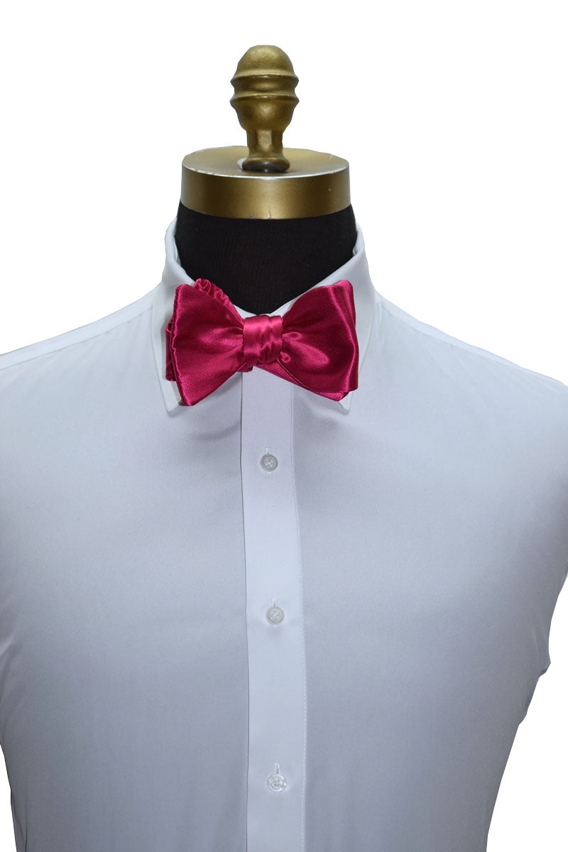 White tuxedo shirt with a hot-pink silk "tie-yourself" bow tie on a mannequin against a white background