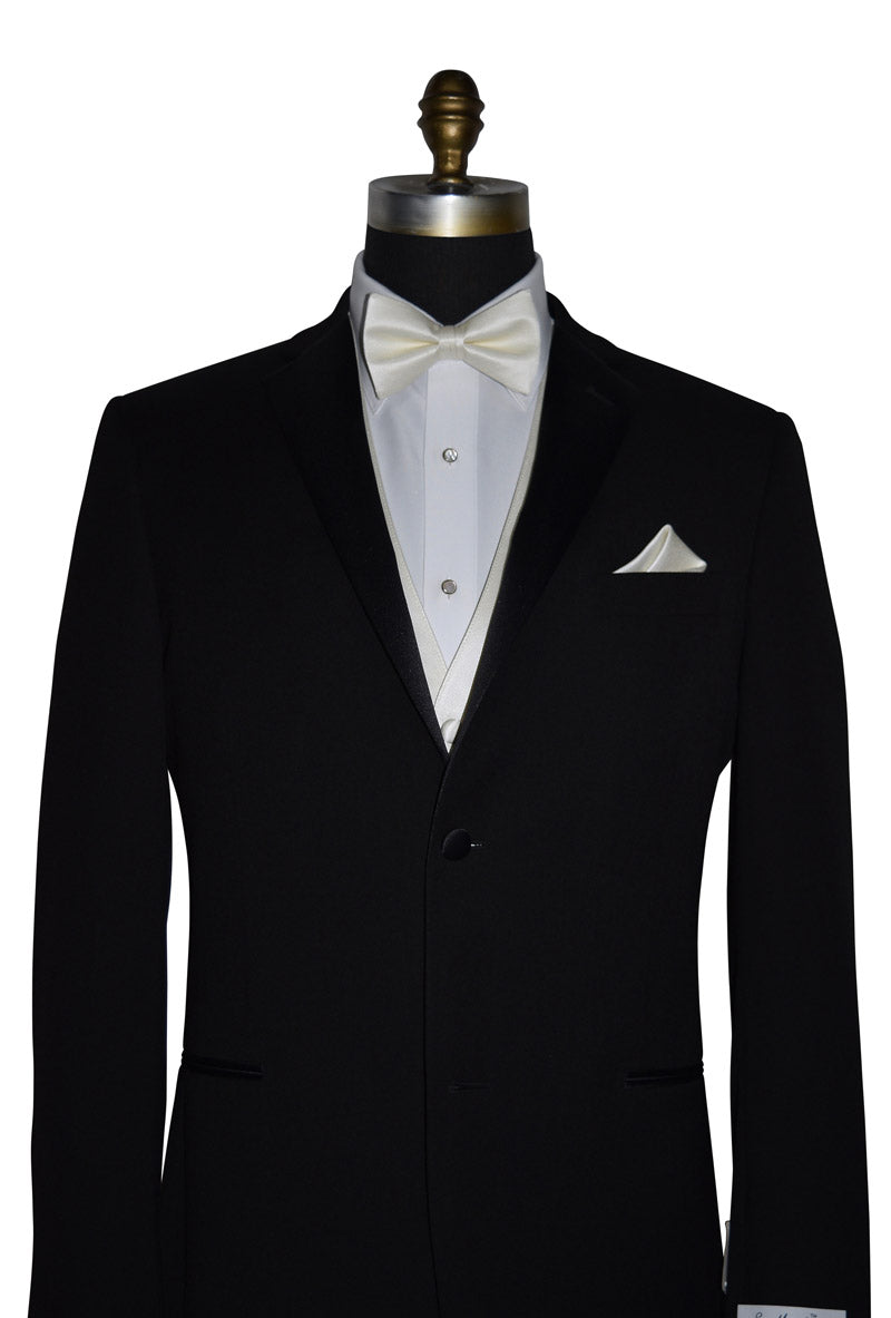 mannequin wearing a black tuxedo with an ivory bowtie and vest against a white background