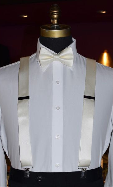 mannequin wearing ivory suspender with a white tuxedo shirt and an ivory bowtie against a dark background
