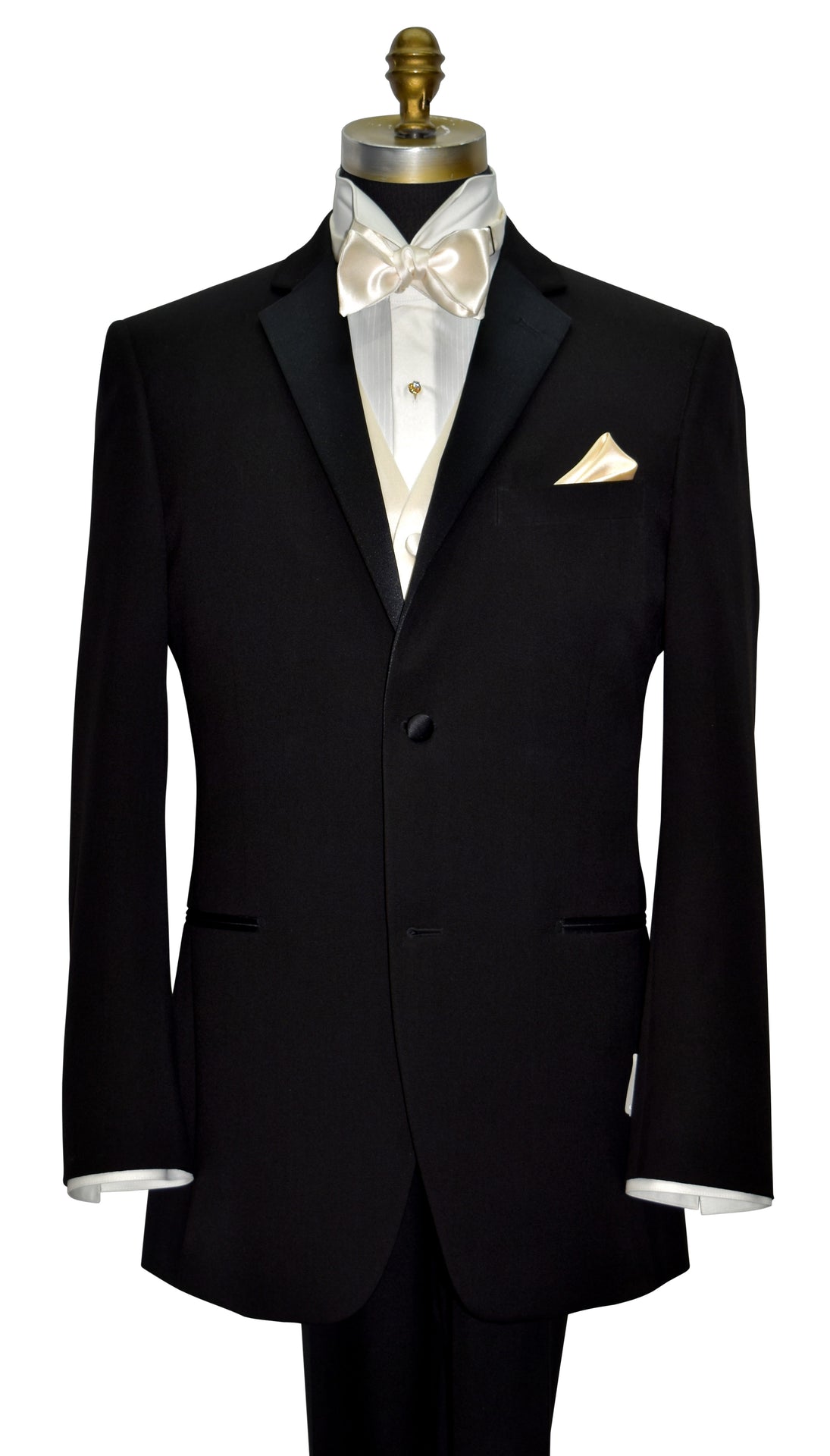 Black tuxedo with ivory shirt with an ivory satin tuxedo vest and ivory satin bow tie on a mannequin against a white background