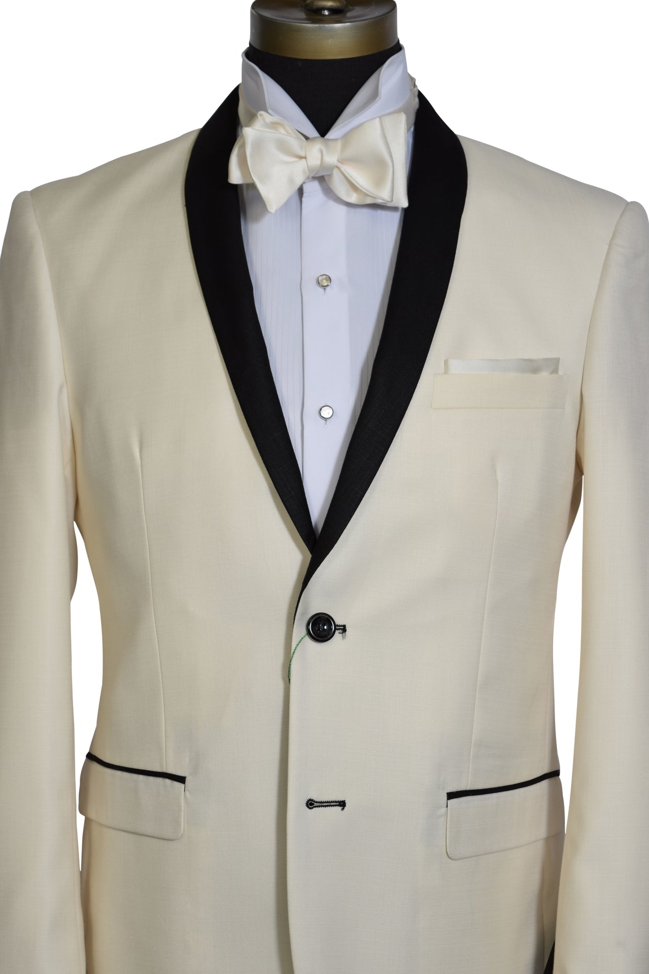 very close-up ivory tuxedo with black shawl collar, a white tuxedo shirt and an ivory bowtie against a white background
