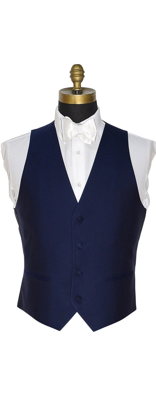 Navy blue tuxedo vest on a mannequin with a white shirt against a white background