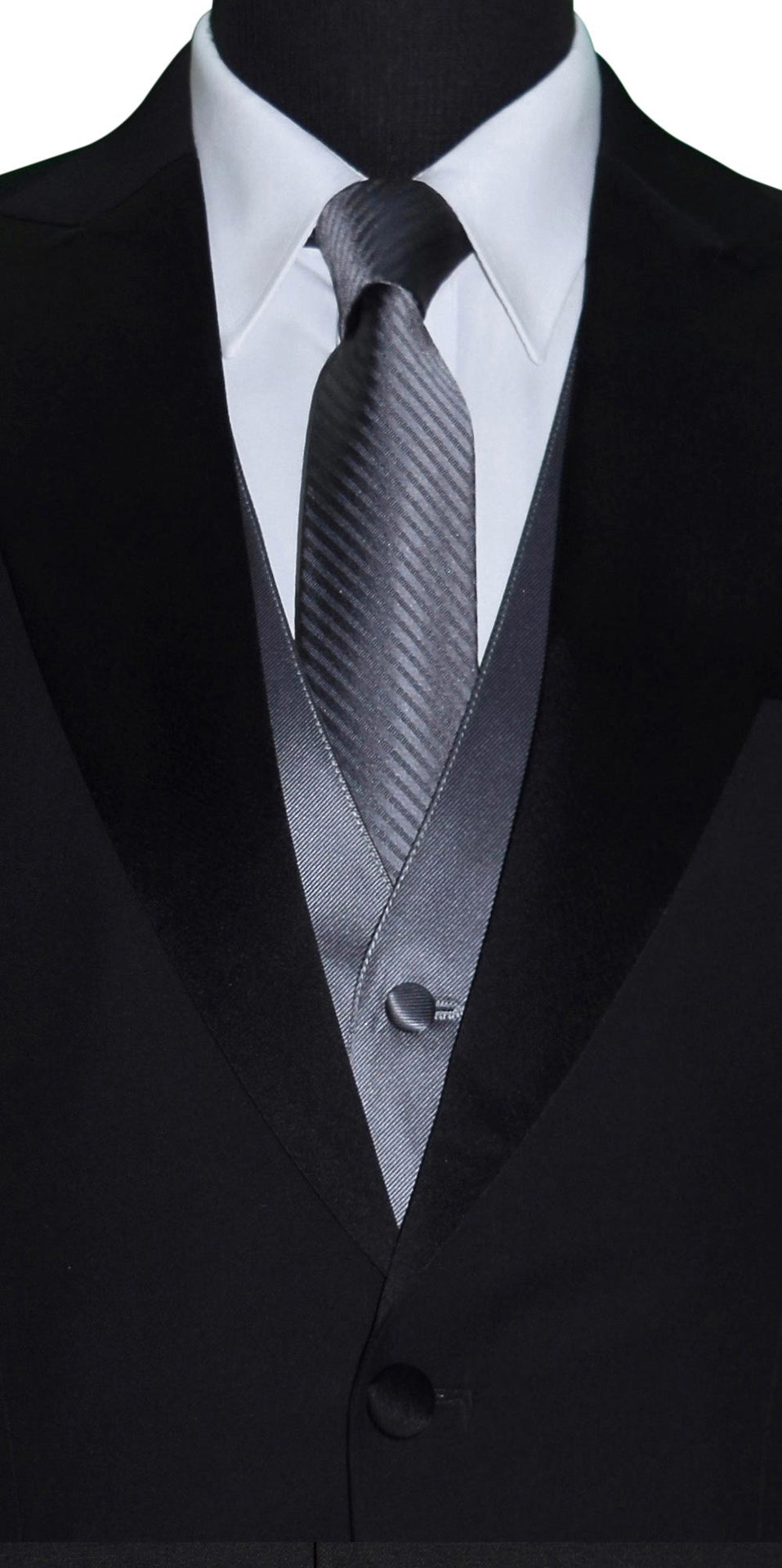 very close up mannequin wearing a black peak lapel tuxedo with a white shirt and charcoal satin vest and charcoal necktie with a subtle charcoal stripe against a white background