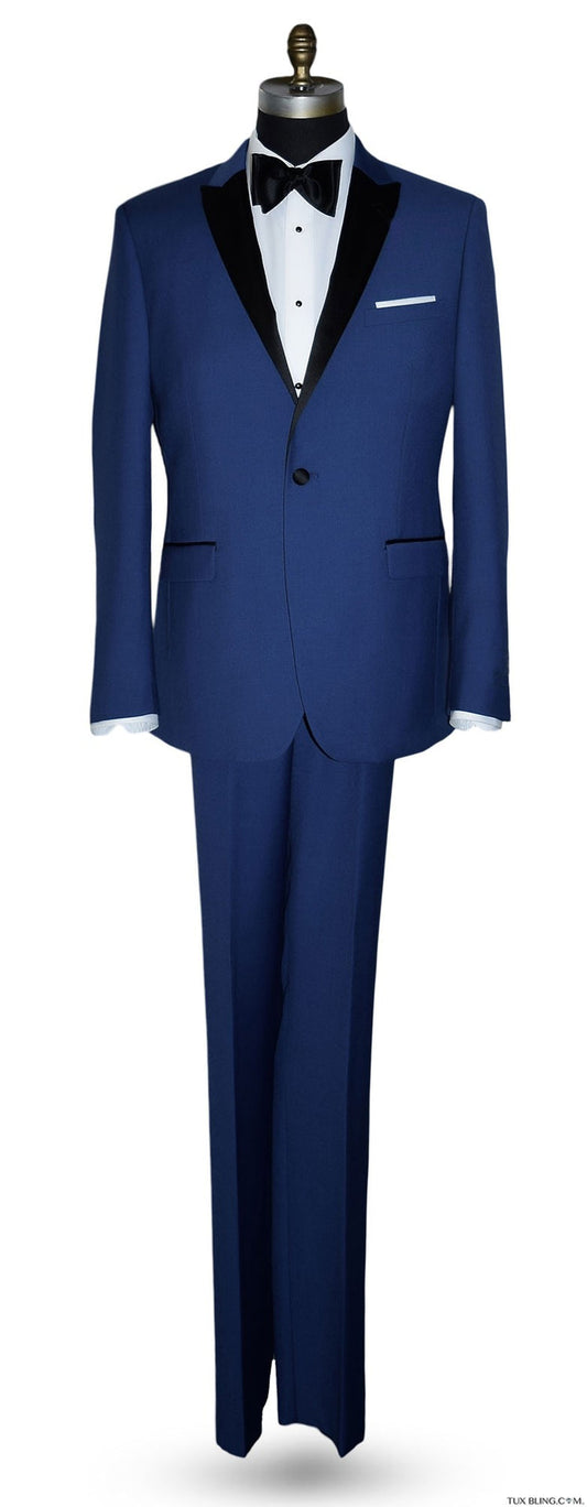 Mannequin wearing a royal-blue tuxedo with black peak lapel, royal blue trousers, and a black satin bowtie, against a white background.