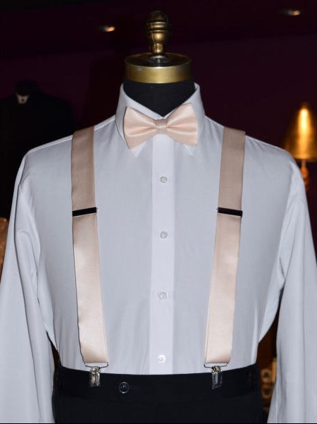mannequin with white dress shirt wearing nude color "pre-tied" bowtie and nude color satin suspenders against a dark background