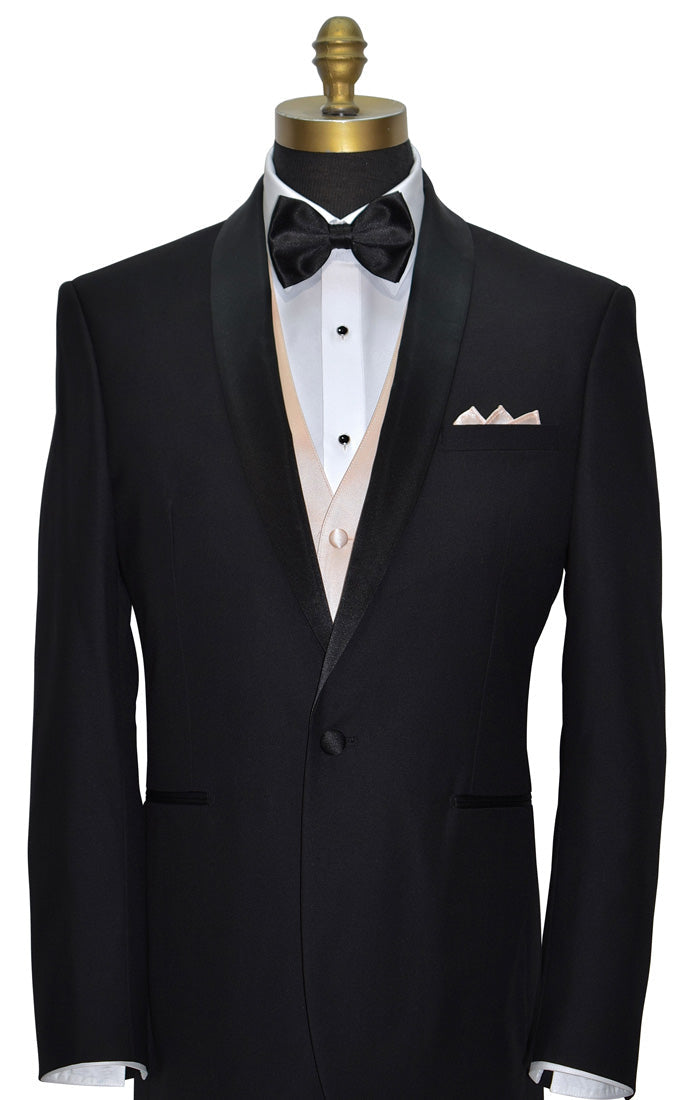 Black shawl-collar tuxedo with white tuxedo shirt, nude tuxedo vest- black "pre-tied" bow tie, and petal pocket square, black studs and cufflinks, on a mannequin against a white background.