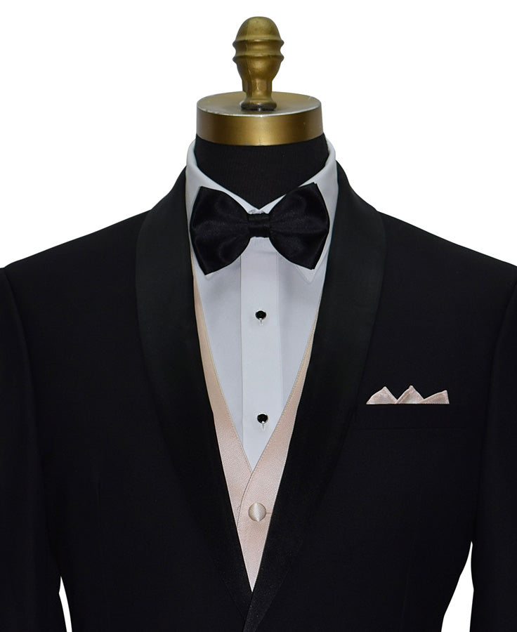 close-up front view - Black shawl-collar tuxedo with white shirt, nude tuxedo vest- black "pre-tied" bow tie, and petal pocket square on a mannequin.