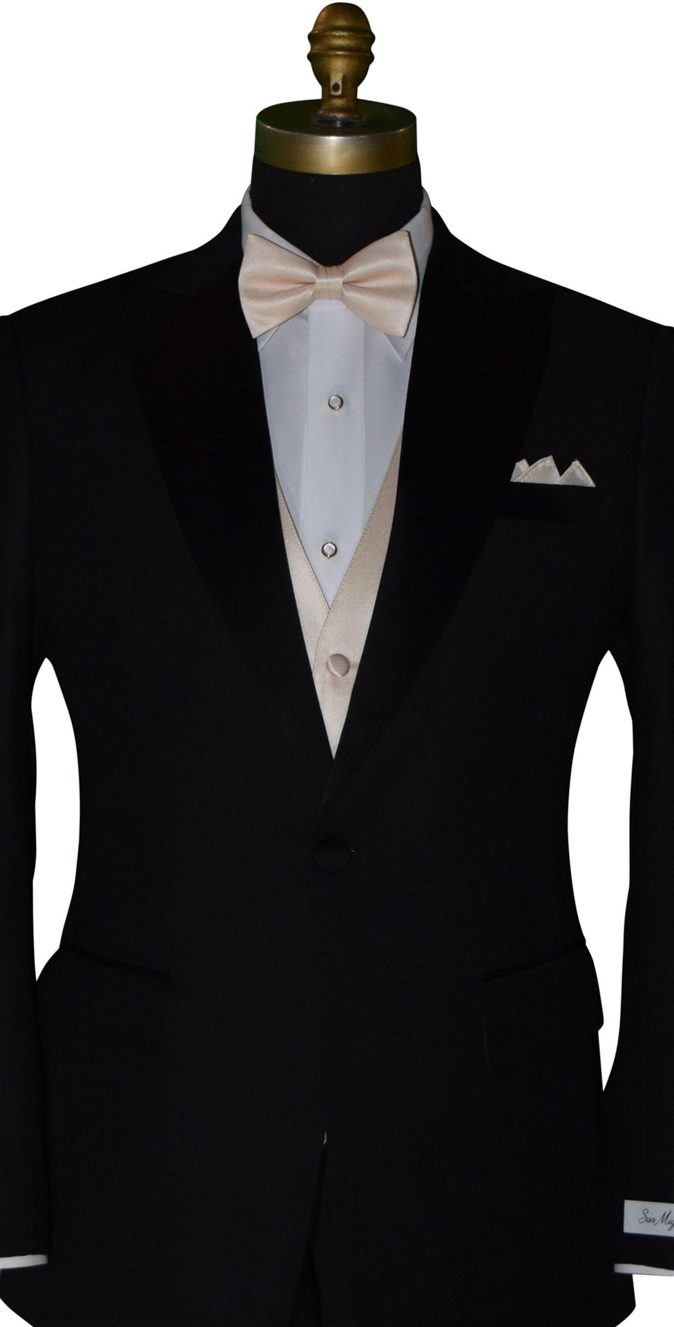 close-up Black tuxedo with nude tuxedo vest and nude "re-tied" bowtie against a white background