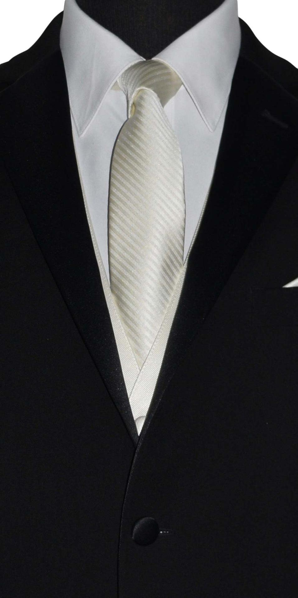 close-up front view Black suit with a white dress shirt and off-white colored necktie on a plain background
