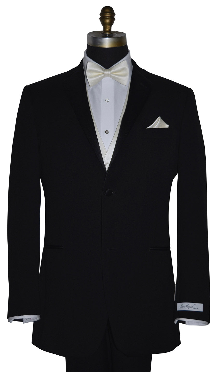 Black tuxedo with "San Miguel Especial" branded label on a mannequin with a white shirt and off-white tuxedo vest and off-white bow tie against a white background