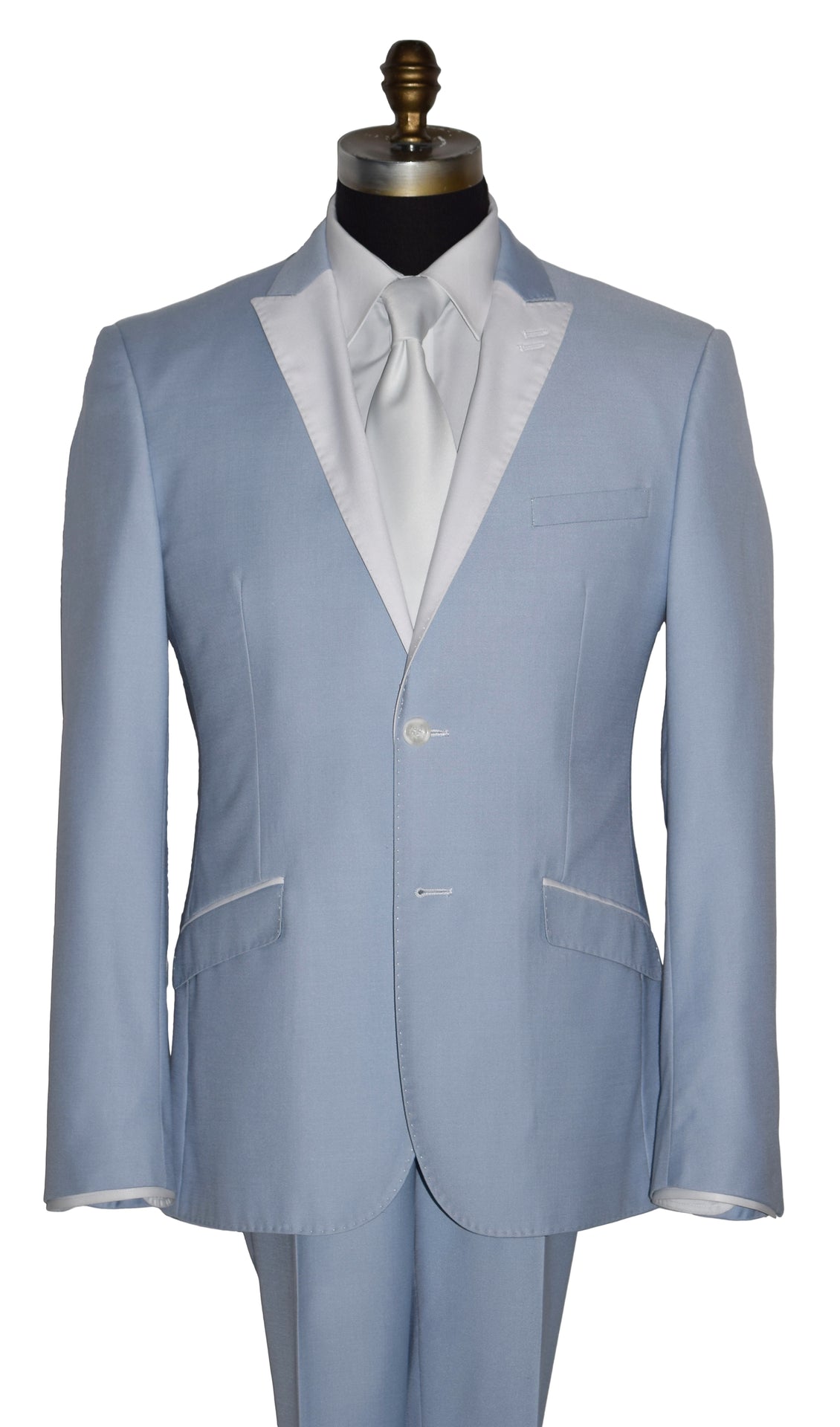close-up life size mannequin wearing a powder-blue tuxedo with a white shirt and a white satin necktie on a mannequin against a white background