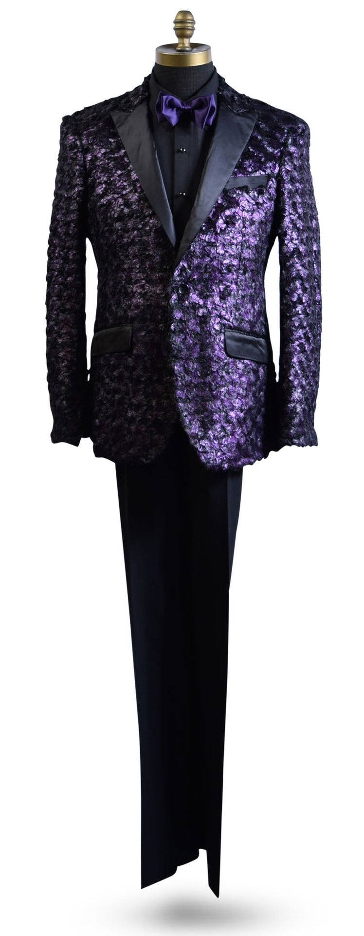life size mannequin wearing a purple tuxedo with black lapels with a black tuxedo shirt and purple bowtie against a white background