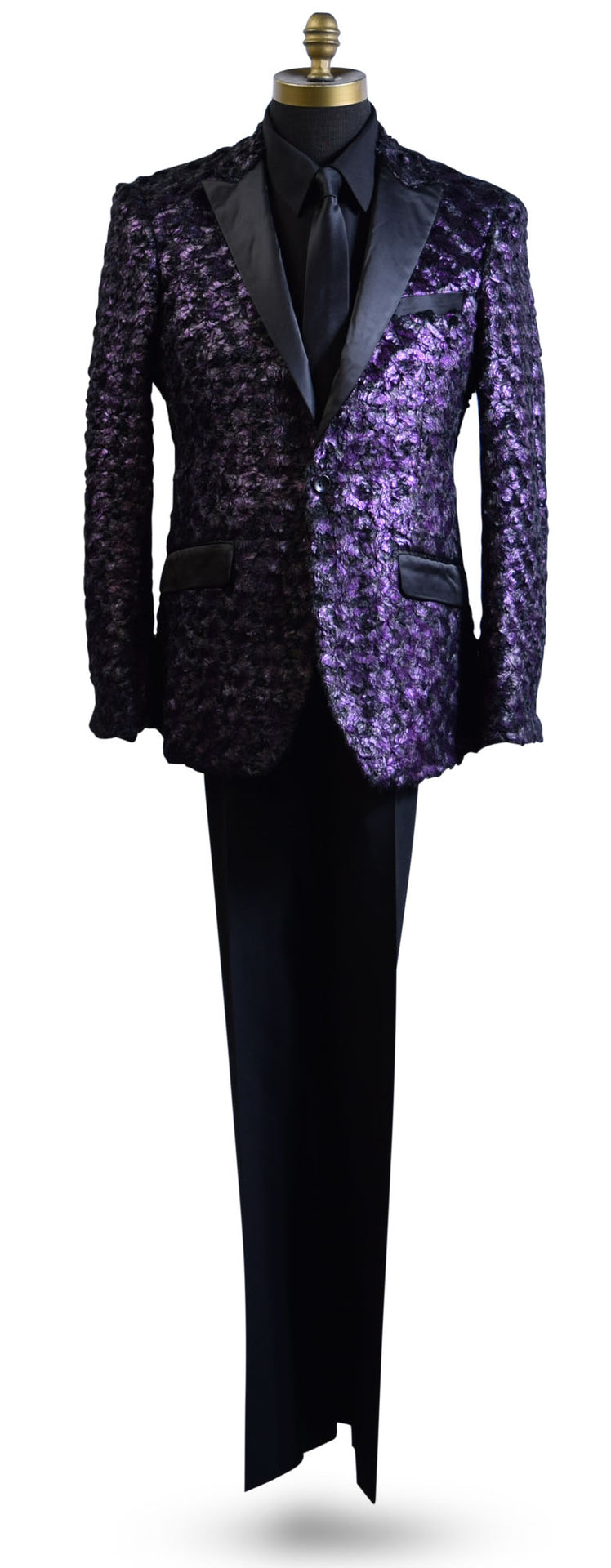 life size mannequin wearing a purple tuxedo with black lapels with a black tuxedo shirt and black satin necktie against a white background