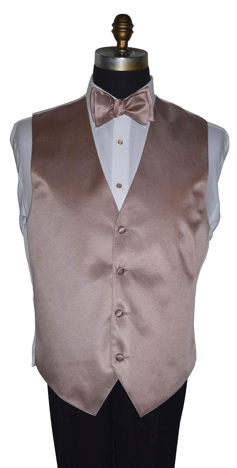 rose gold tuxedo vest and bowtie on a mannequin with a white tuxedo shirt wearing pearl cufflinks and studs with gold setting against a white background