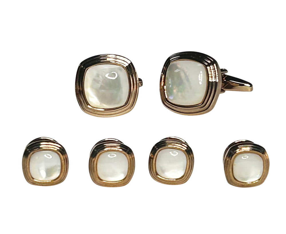 Set of mother-of-pearl cufflinks and studs with gold setting on a white background
