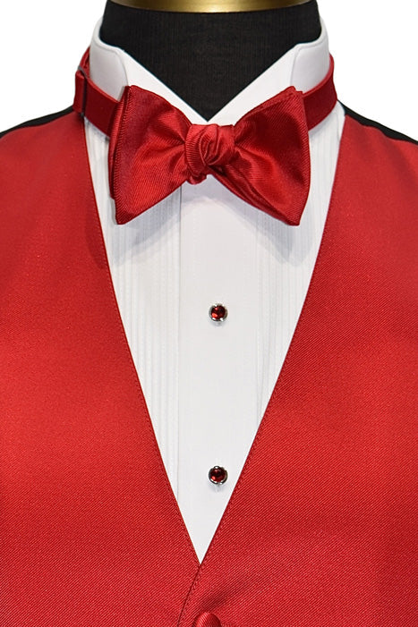 ruby red studs and cufflinks on display with a white tuxedo shirt and red vest and bowtie