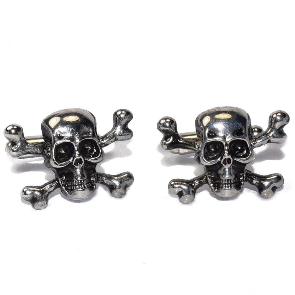 Pair of silver "skull and crossbones" cufflinks on a white background