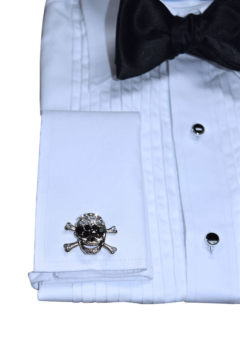 closse up of a white tuxedo shirt wearing a black bowtie and "skull and crossbones" cufflinks against a white background