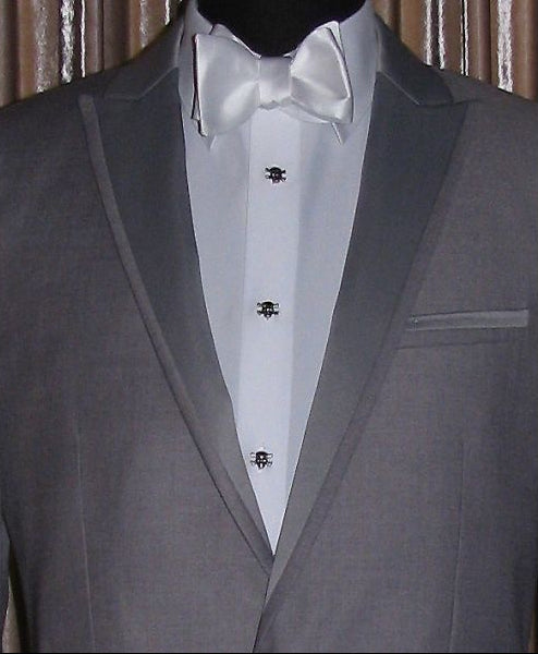 close-up front view Gray tuxedo on a mannequin with a white shirt and white bowtie with "skull and bones" studs and cufflinks