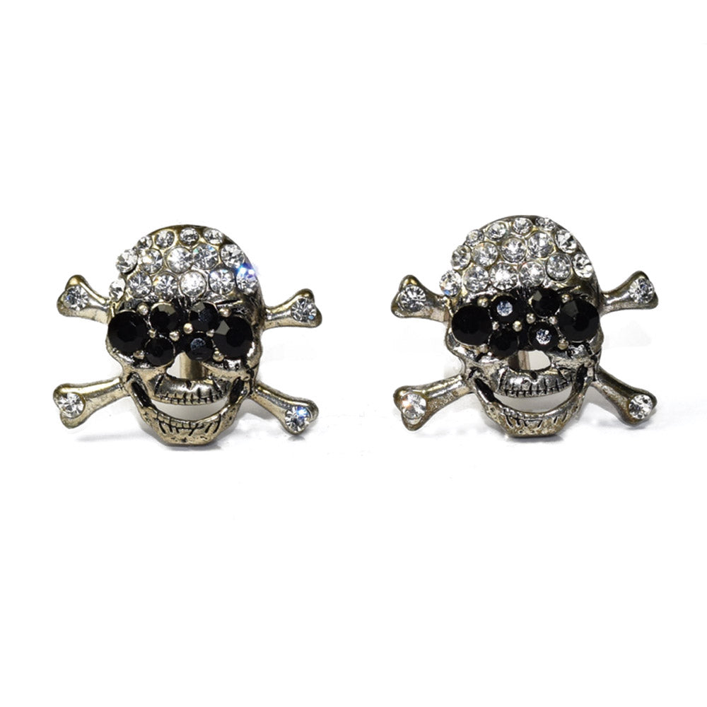 Pair of largeskull and crossbones cufflinks with gemstones on a white background