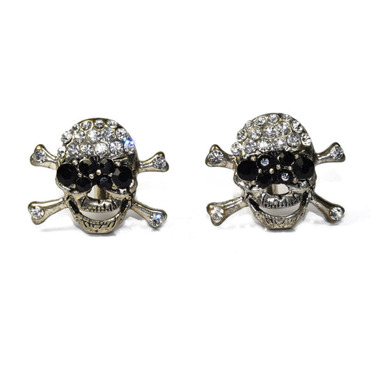 Pair of largeskull and crossbones cufflinks with gemstones on a white background