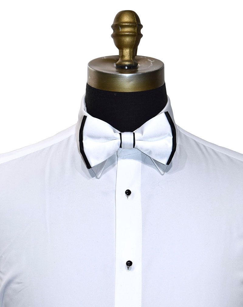 White dress shirt with a black bowtie with white trim on the edges on a mannequin.