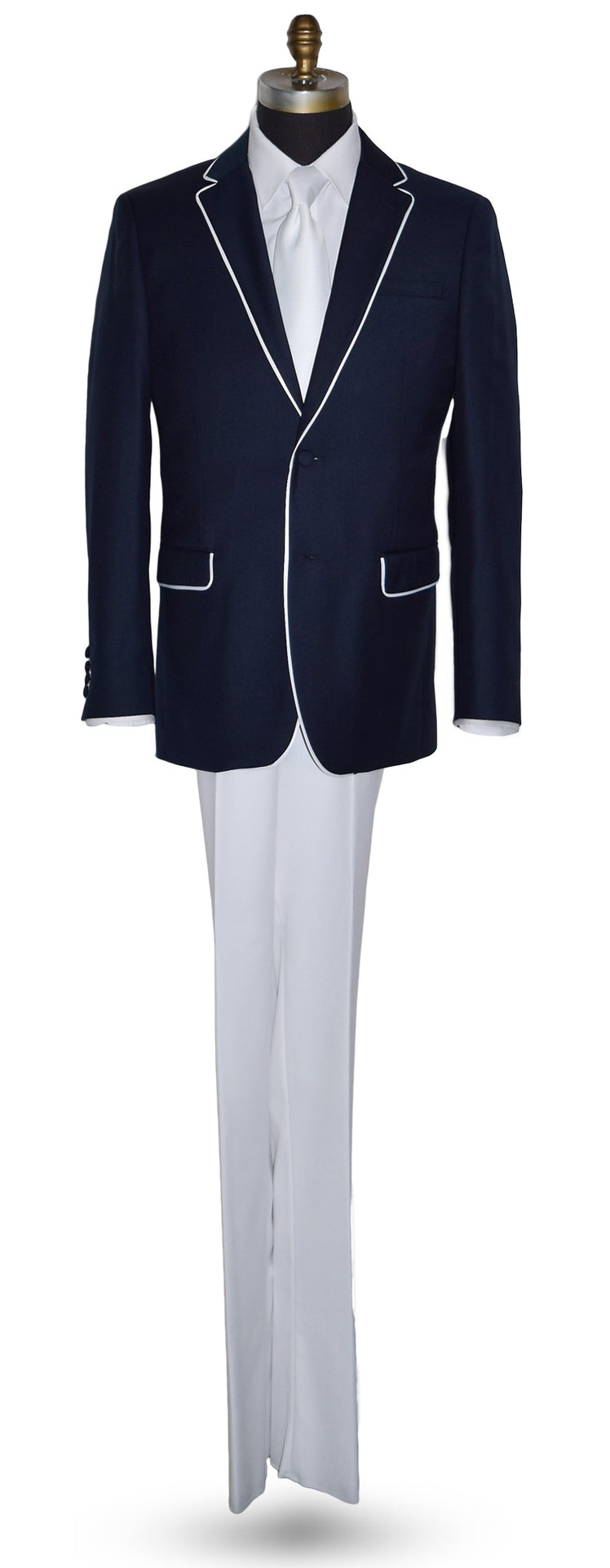 Navy blazer with white trim on a mannequin with white pants and a white shirt with a white low-sheen necktie against a white background
