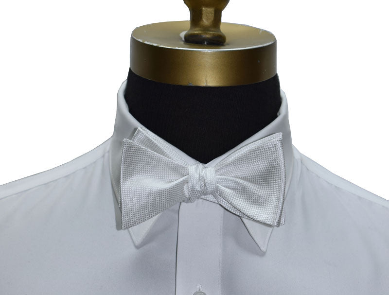 White shirt with a pique bow tie on a mannequin against a white background