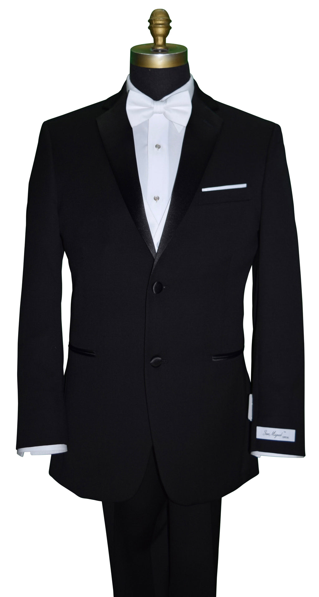 Black tuxedo with a white shirt and white satin vest and white bow tie on a mannequin against a white background